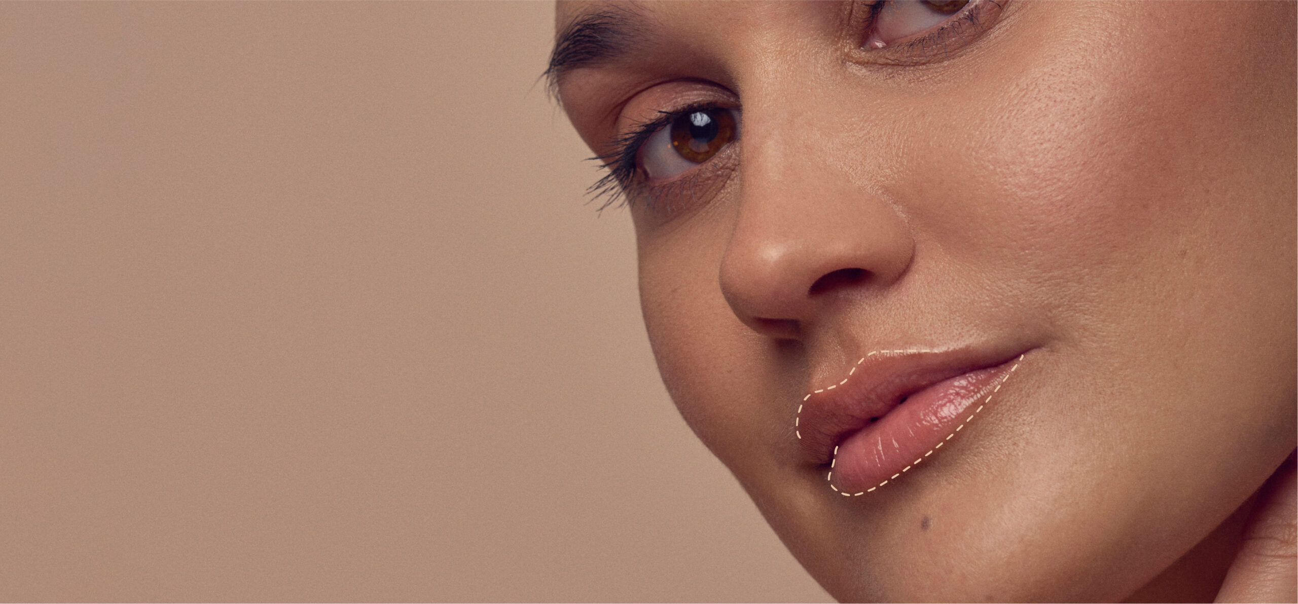 Close-up of a person with smooth, glowing skin and natural makeup. The focus is on the lips and right eye, with a soft, neutral background.